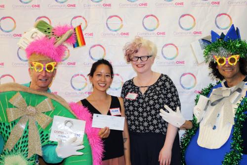 Flora Shum (centre left) and Emily Cook of Paperhouse Outreach Collective receive their Rainbow Grant for the Zine Production and Exchange Program (ZIPE) for LGBTQ+ youth.