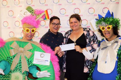 Carlisle and Sage of ORAD receive their Rainbow Grant for the event Draggin' ASL to Pride